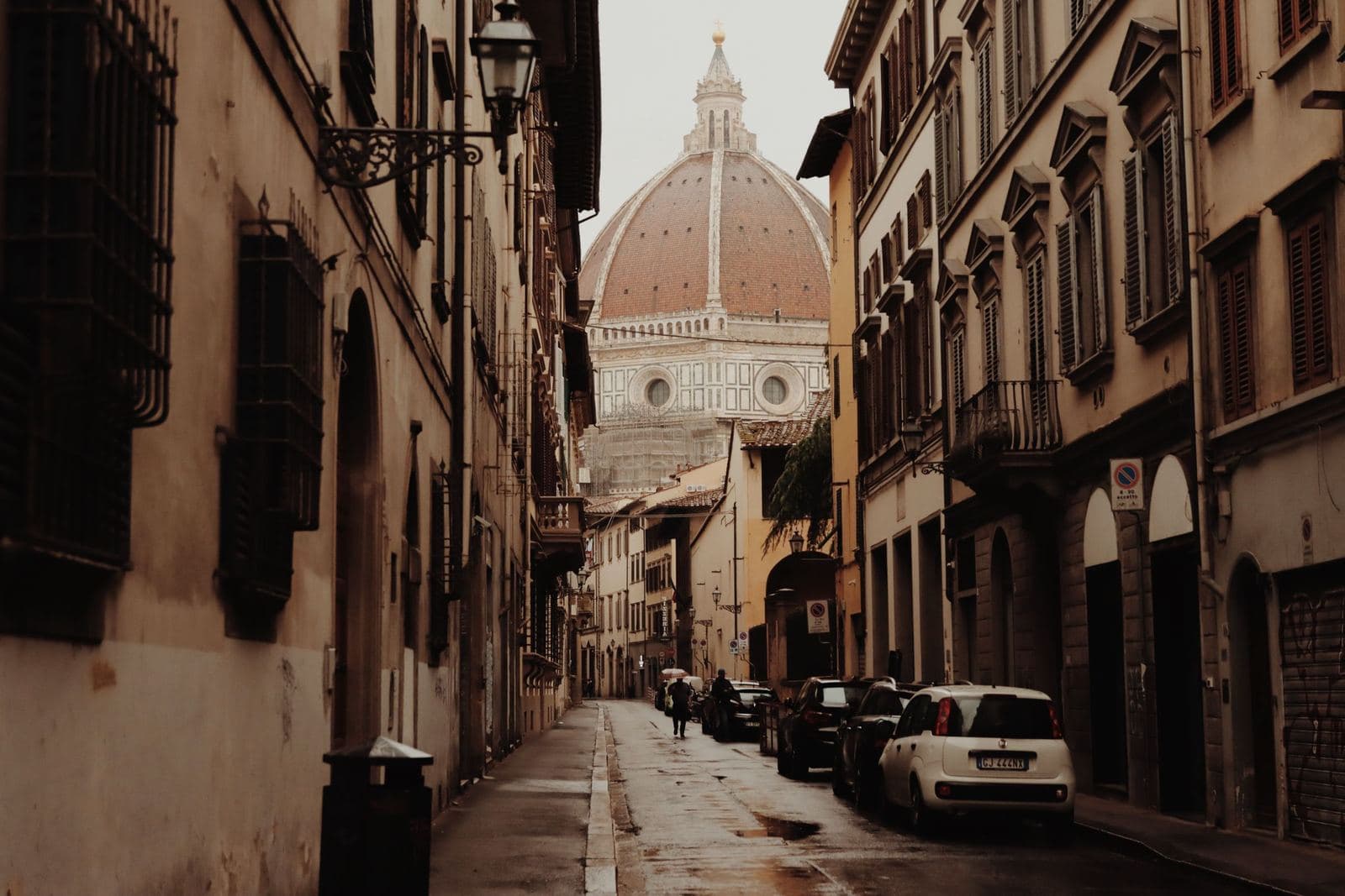 Florence street leading to the cathedral dome, near the Accademia
