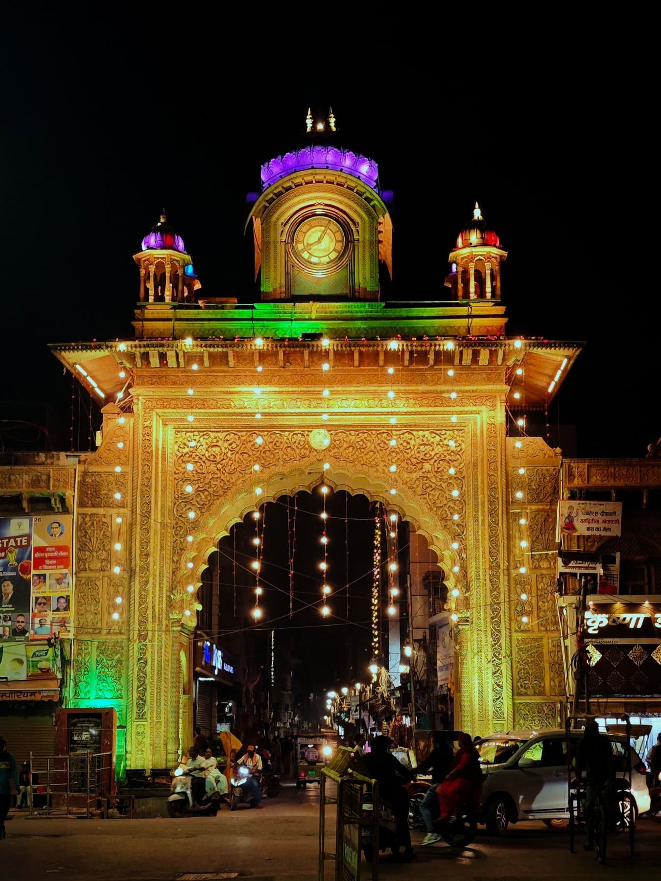 An illuminated heritage gate in Mathura at night