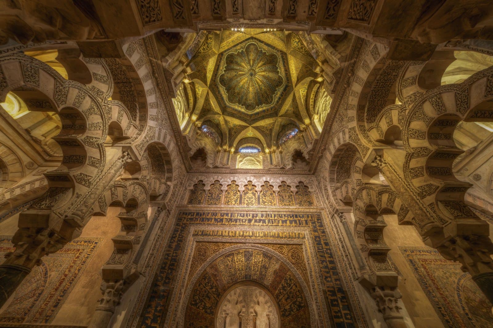 Richly decorated arches and dome inside the Mosque-Cathedral of Córdoba