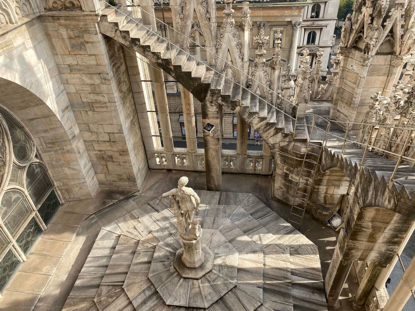 Marble walkways and a statue on the terraces of Milan Cathedral