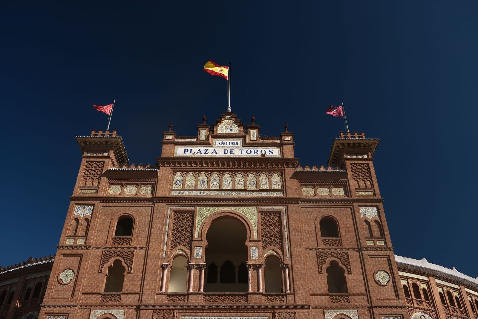 Main gate of the Plaza de Toros de Las Ventas, flags flying