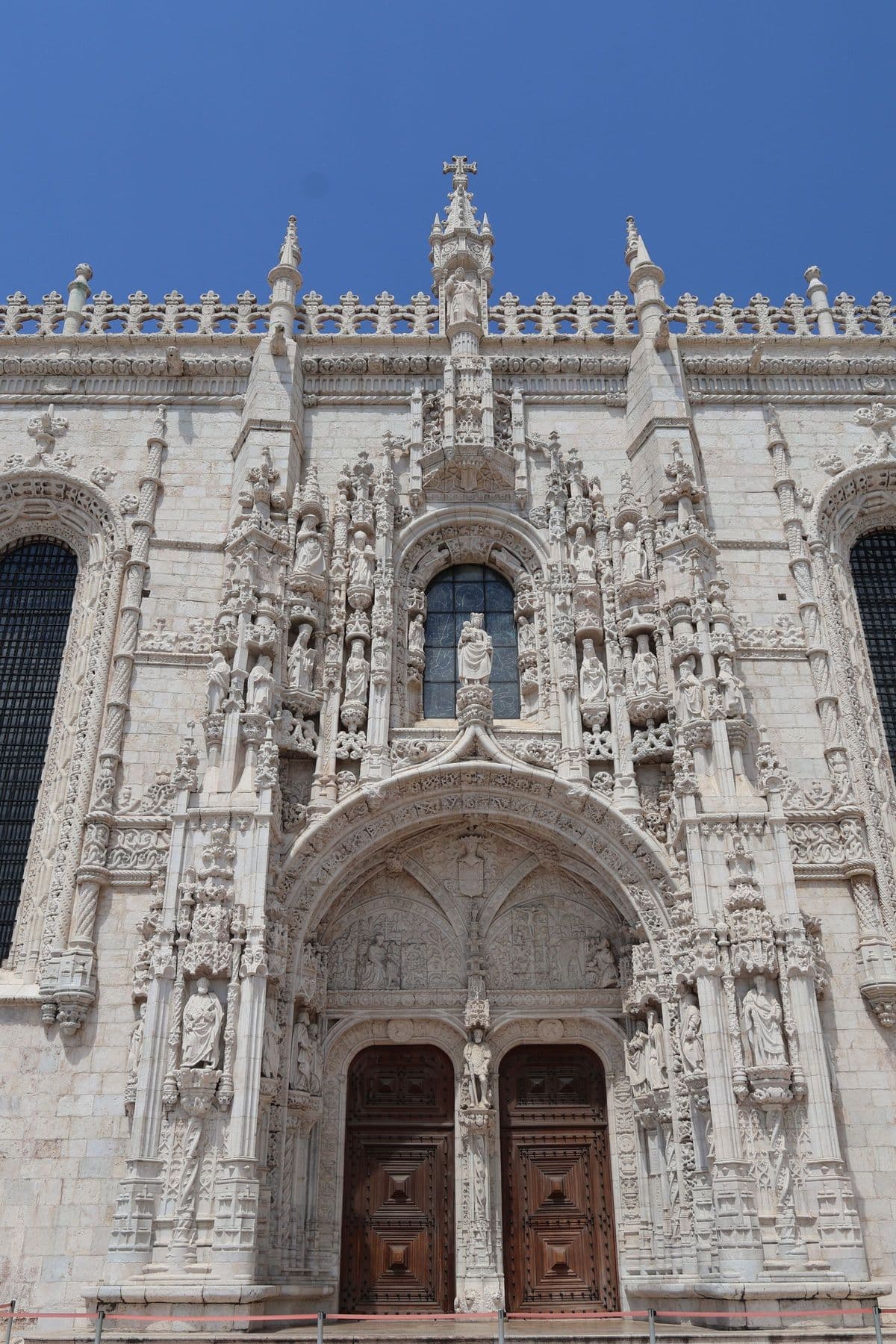 Intricate stone carving around a portal of the Jerónimos Monastery