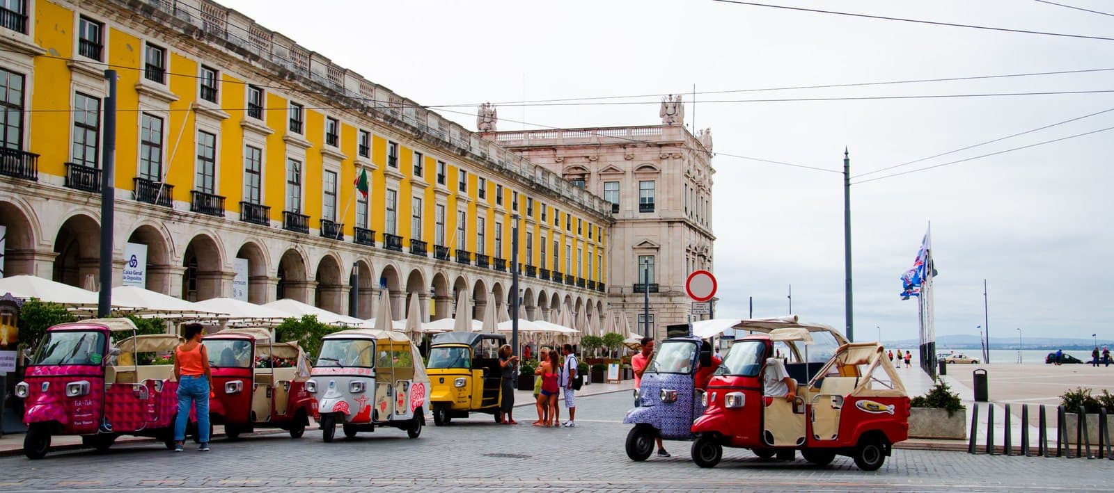 Tuk-tuks lined up on Praça do Comércio in Lisbon