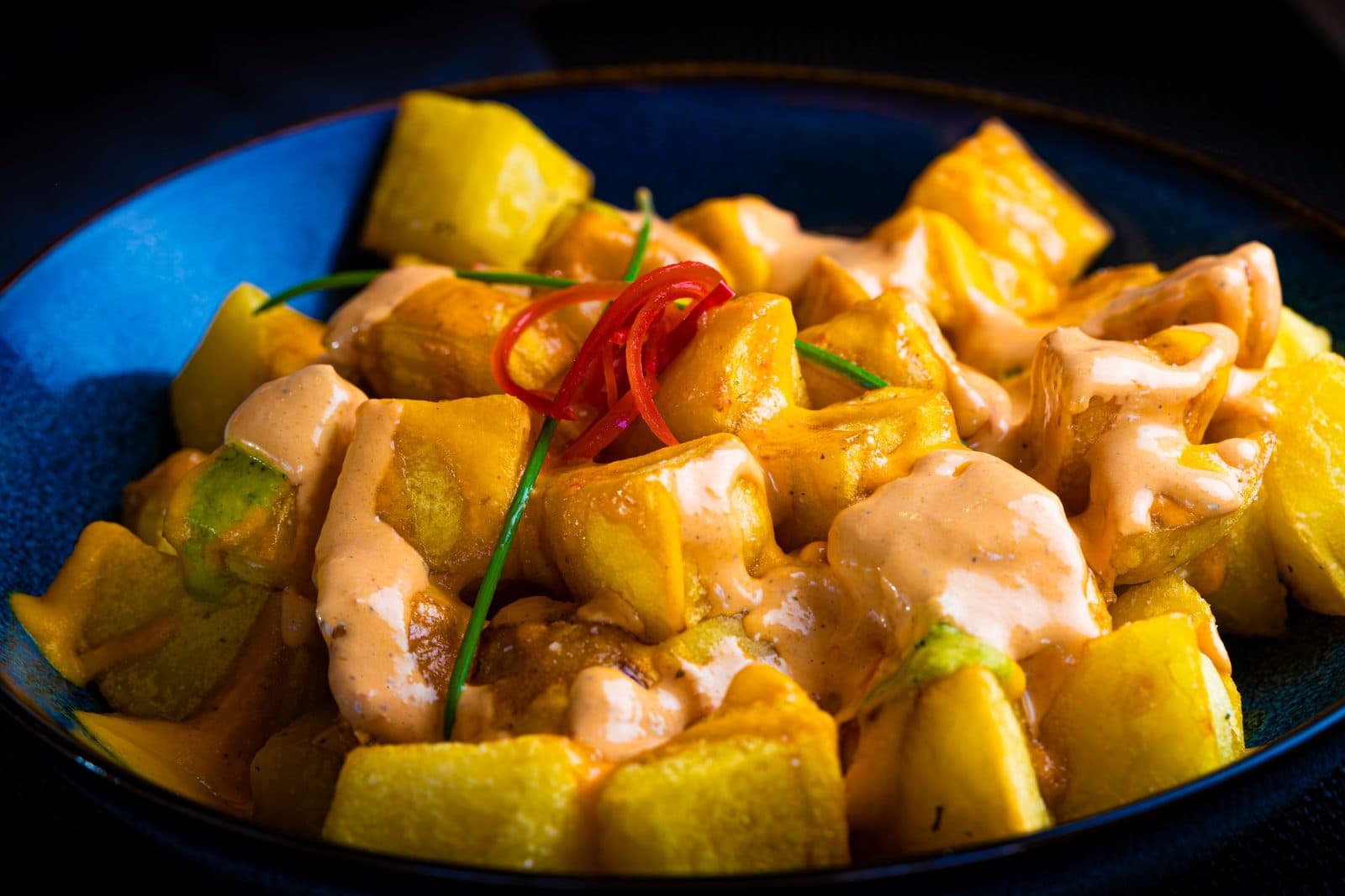 Patatas bravas with spicy sauce and aioli