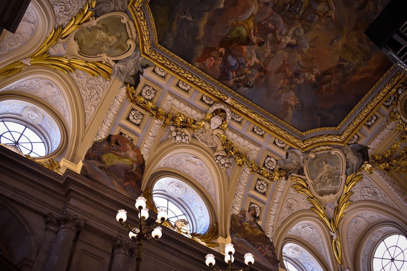 Gilded ceiling and painted vault inside the Royal Palace of Madrid