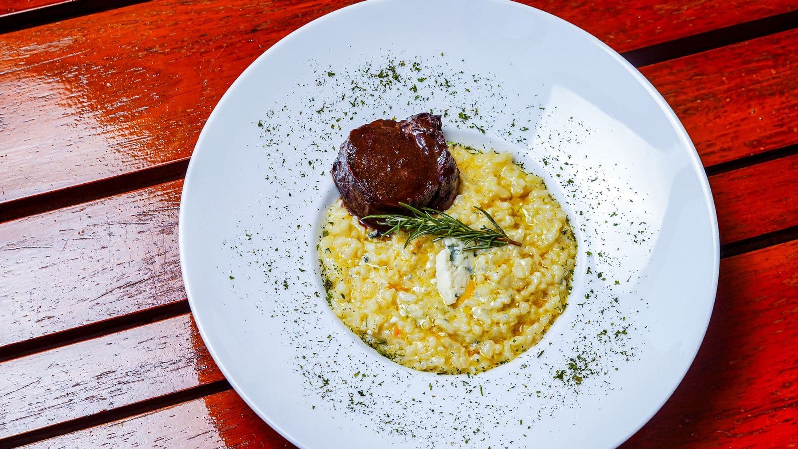Saffron risotto alla milanese served with beef