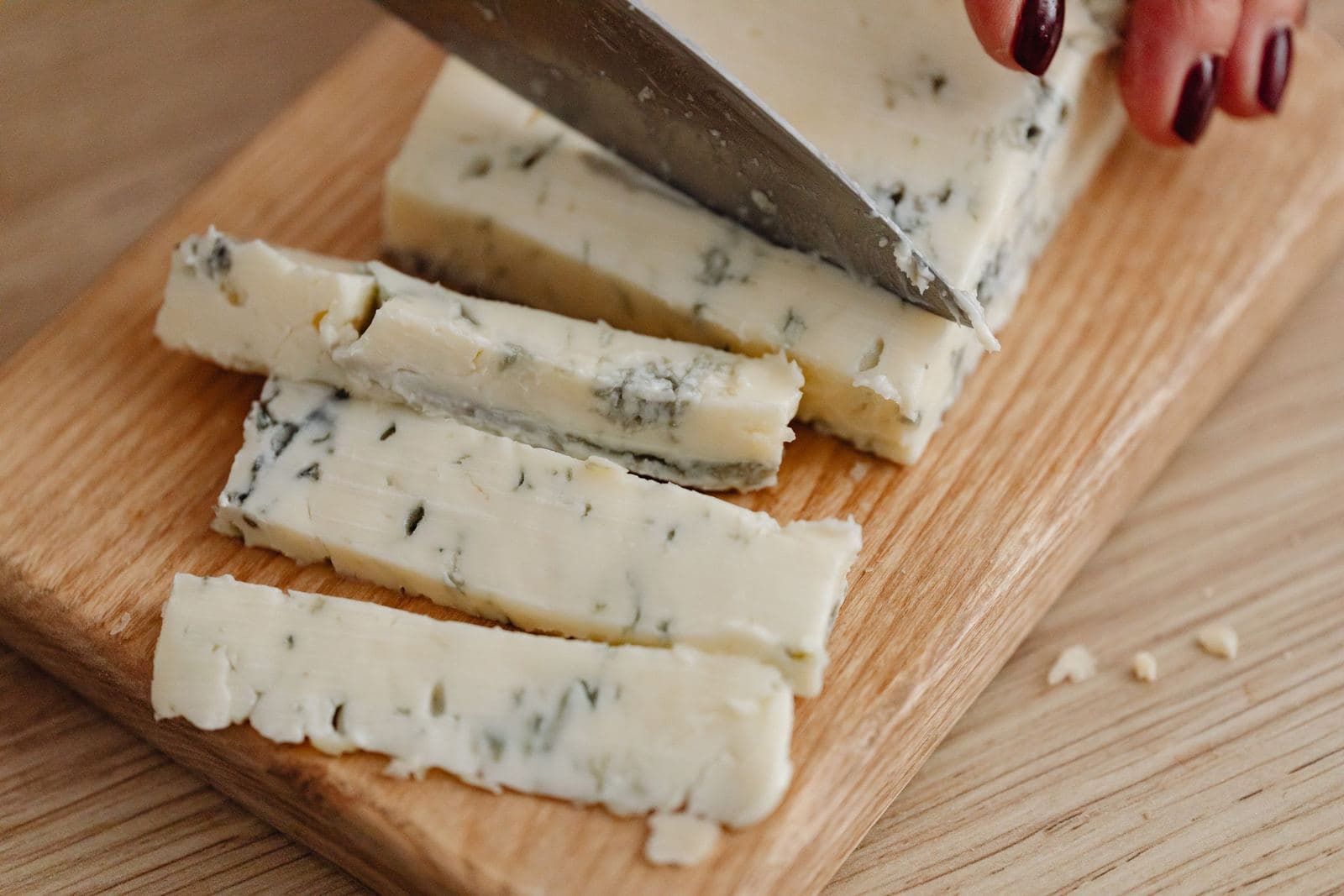 Slicing creamy Gorgonzola cheese