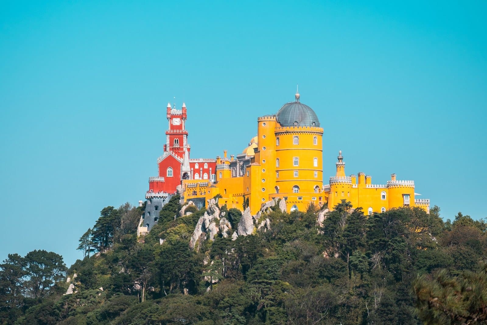 Pena Palace's yellow and red towers on a wooded hilltop