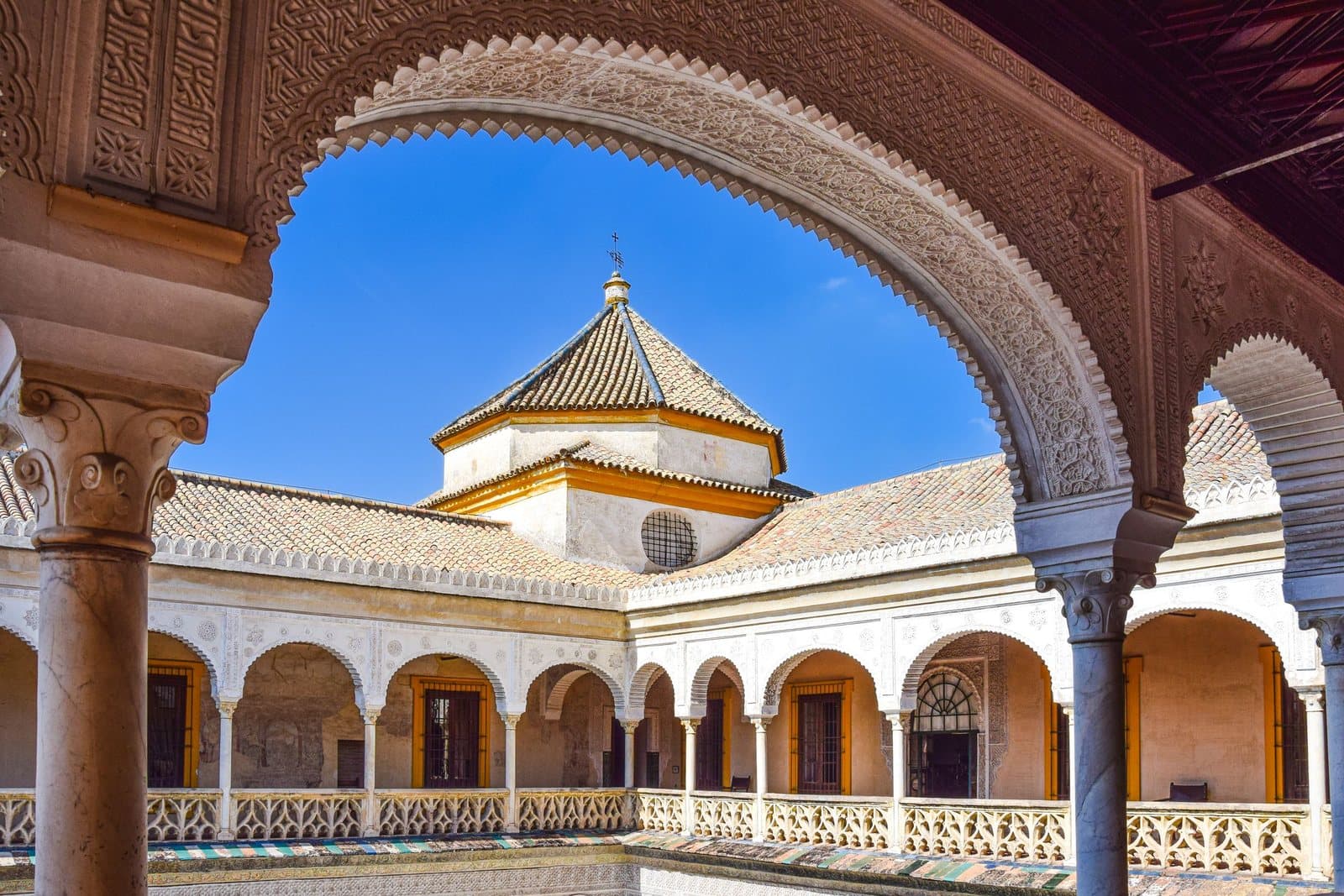 The Casa de Pilatos courtyard seen through a carved arch