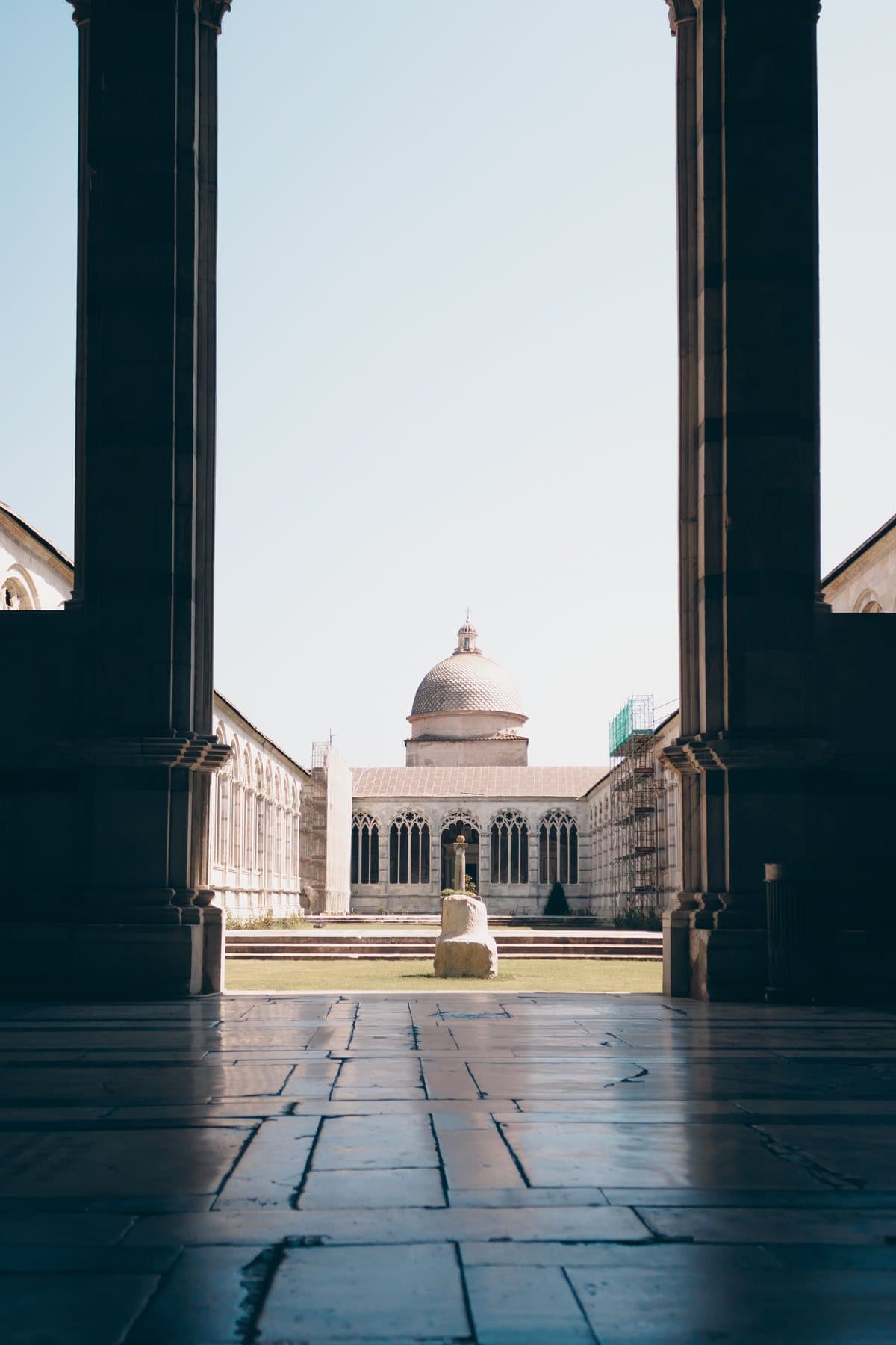 The courtyard of the Camposanto Monumentale seen through an archway