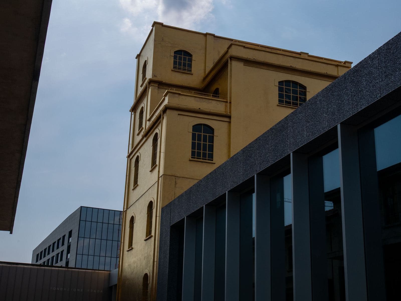 Gold-leaf Haunted House tower beside the Fondazione Prada buildings