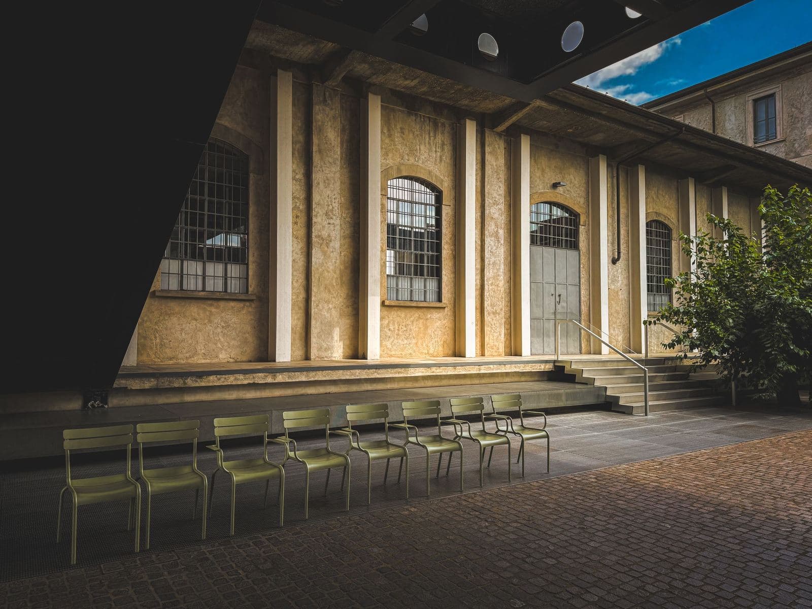 Modern building and courtyard chairs at the Fondazione Prada