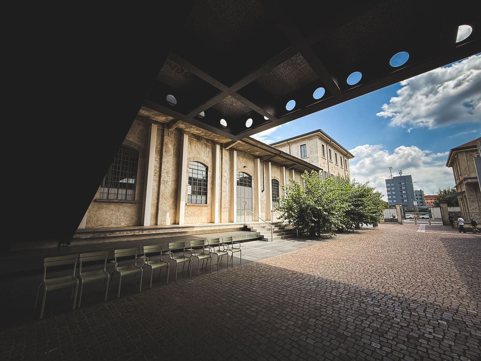Open courtyard of the Fondazione Prada under a blue sky