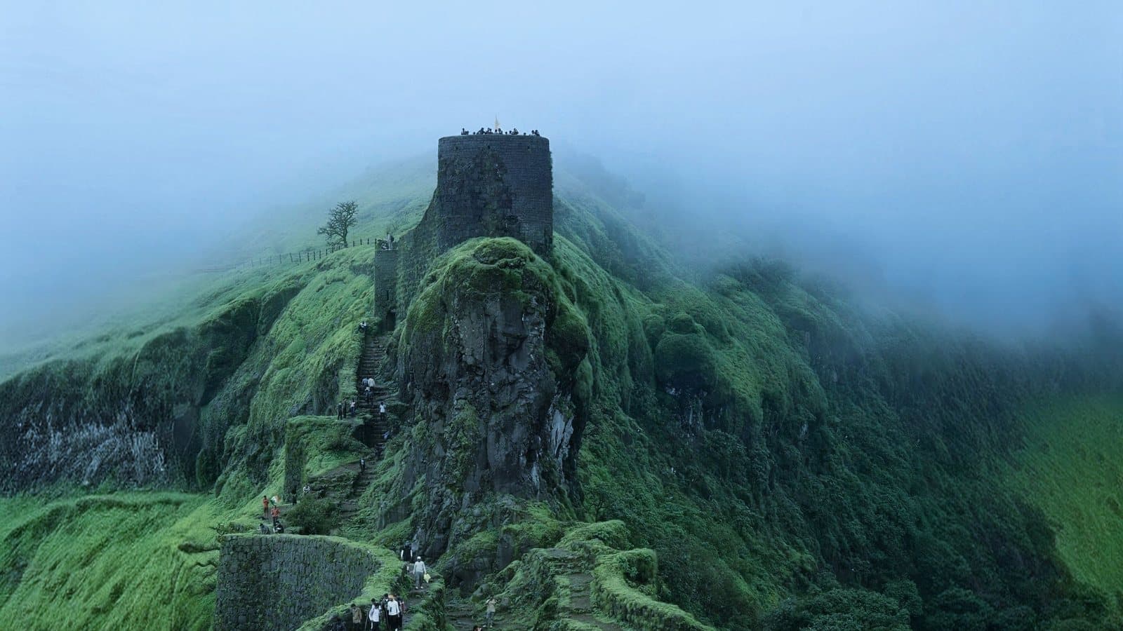 Sinhagad Fort's ramparts above the clouds in the monsoon