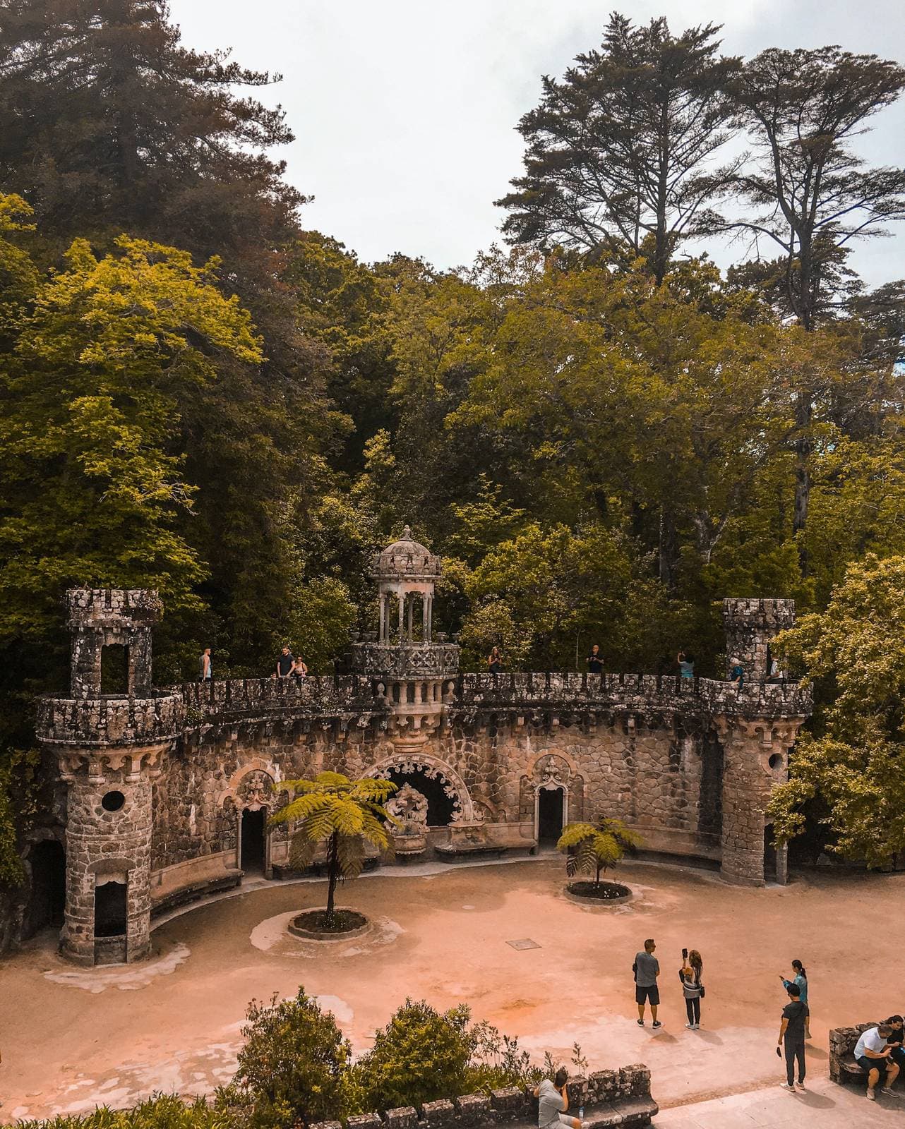 A crenellated stone portal in the gardens of Quinta da Regaleira