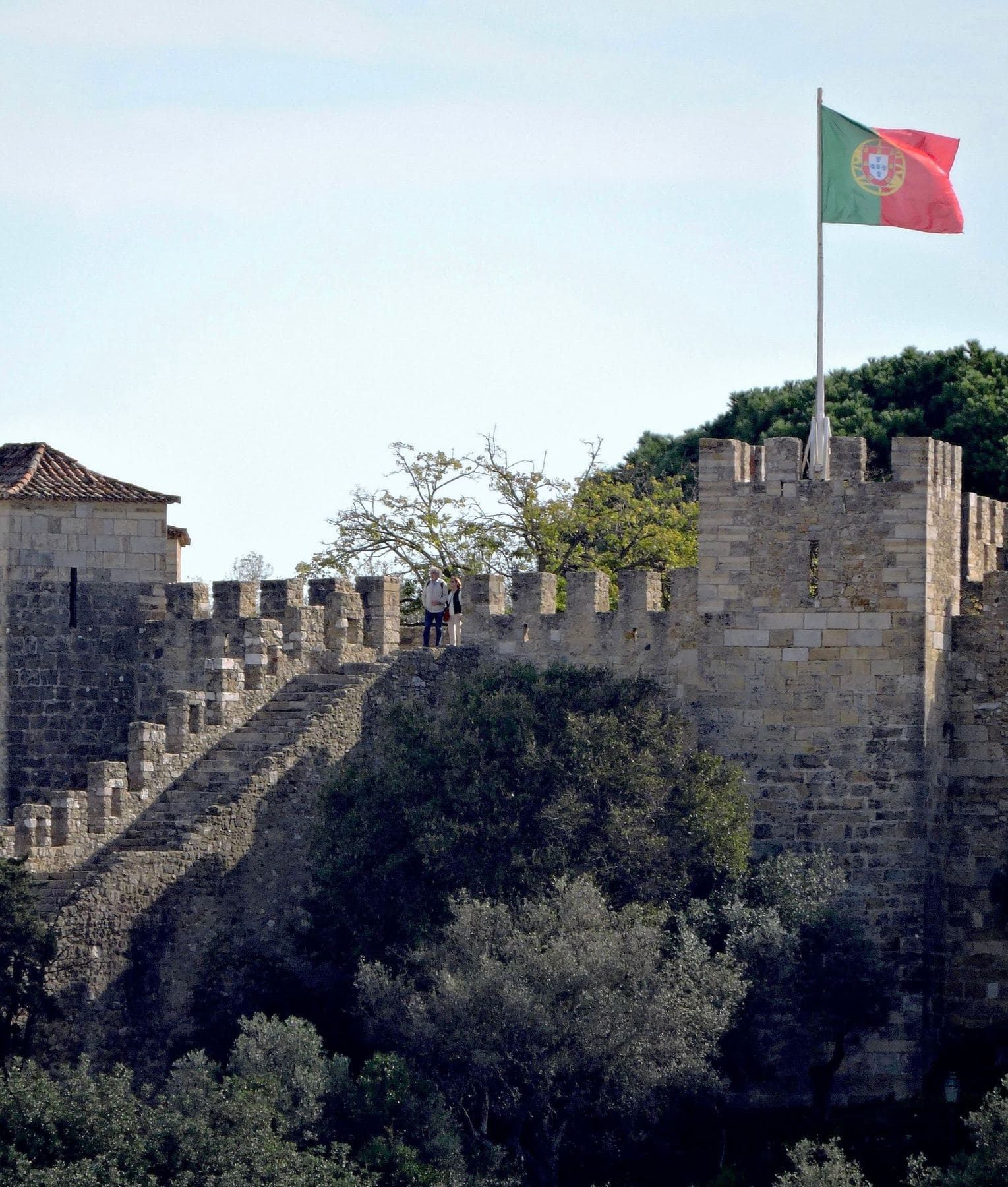The battlements of São Jorge Castle, with the Portuguese flag flying