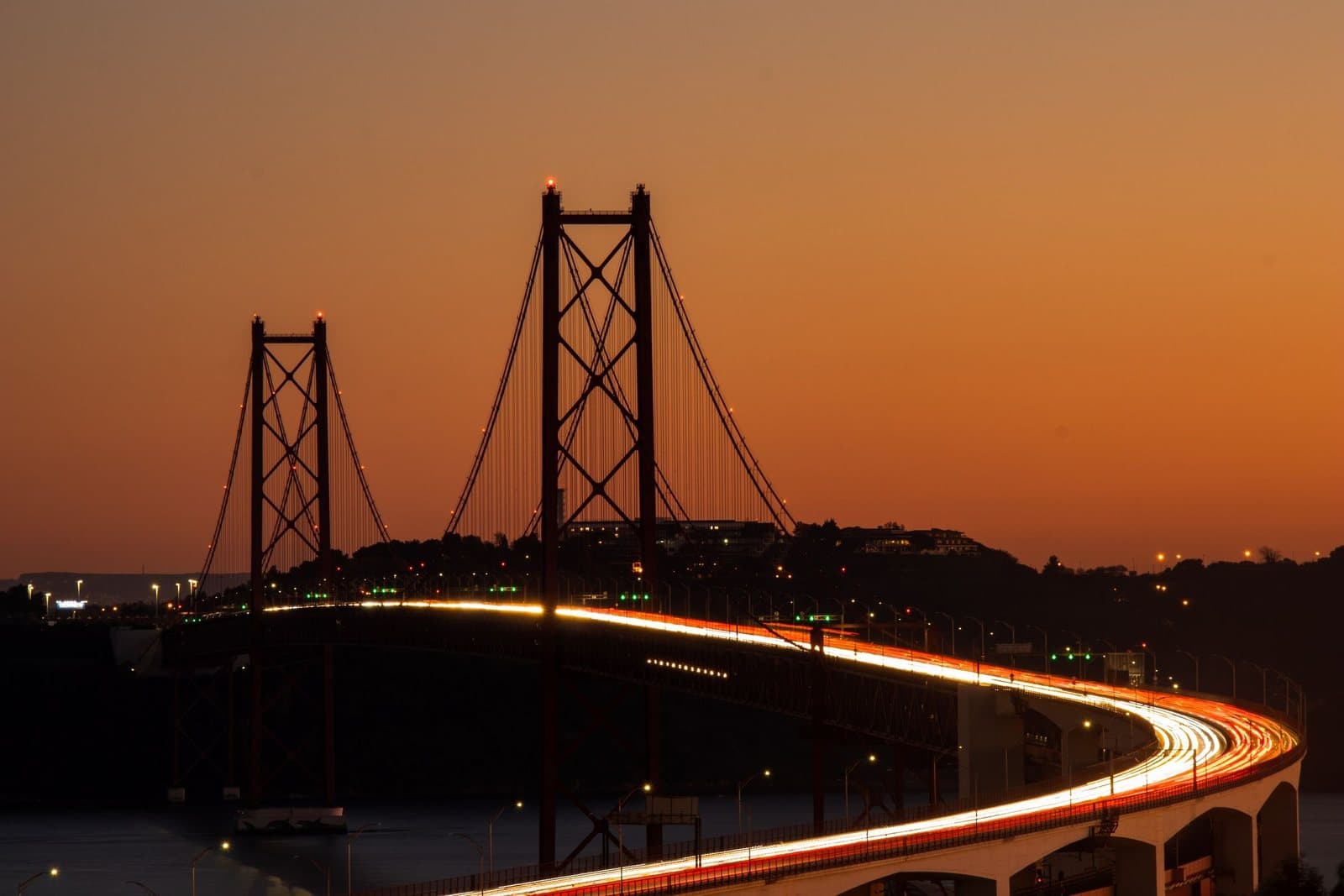 The 25 de Abril Bridge lit at twilight