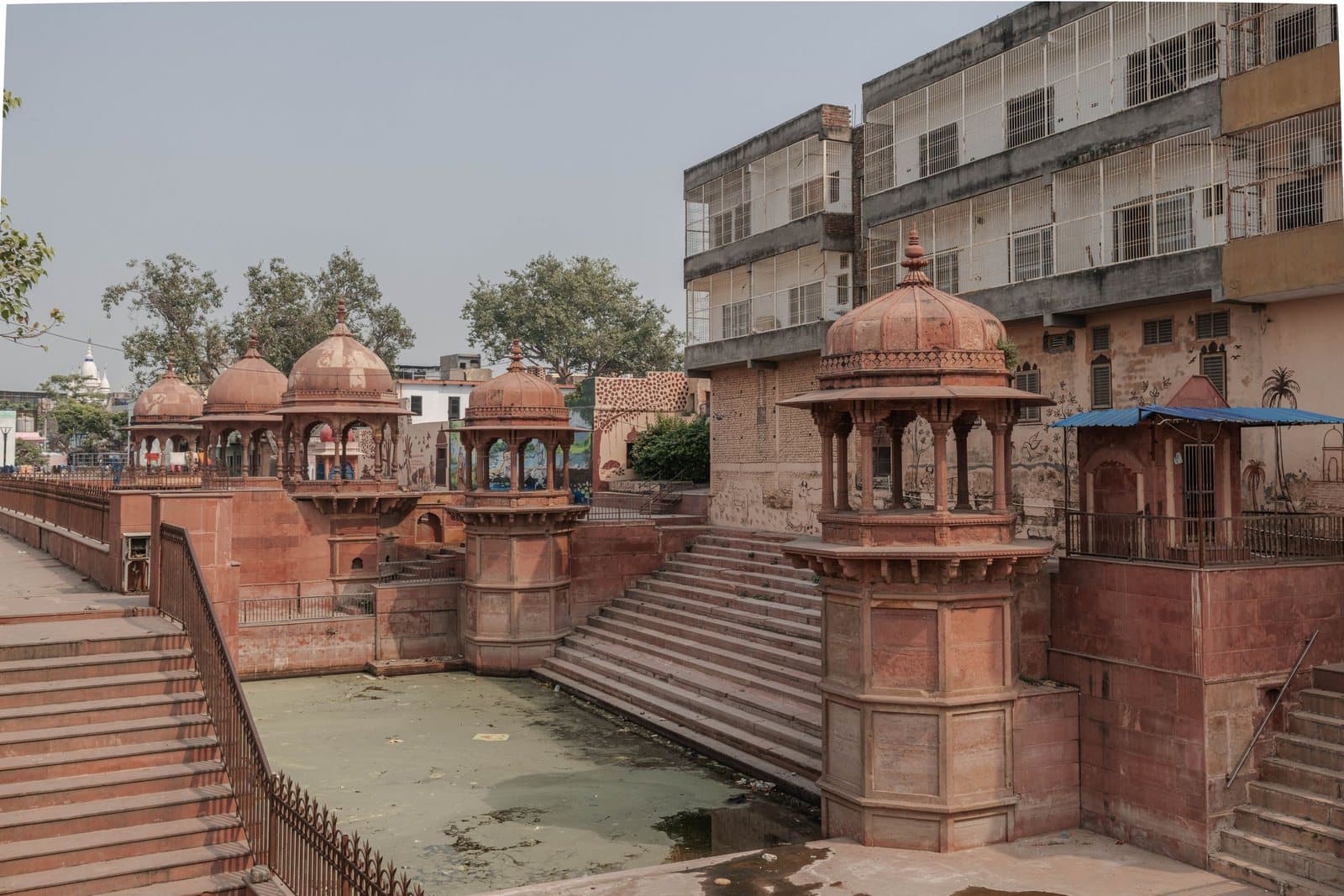 Red sandstone pavilions and steps of an old ghat in Vrindavan
