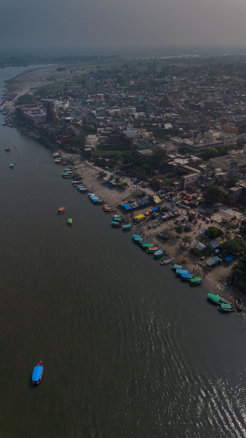 Boats moored along the Yamuna below Vrindavan, seen from above