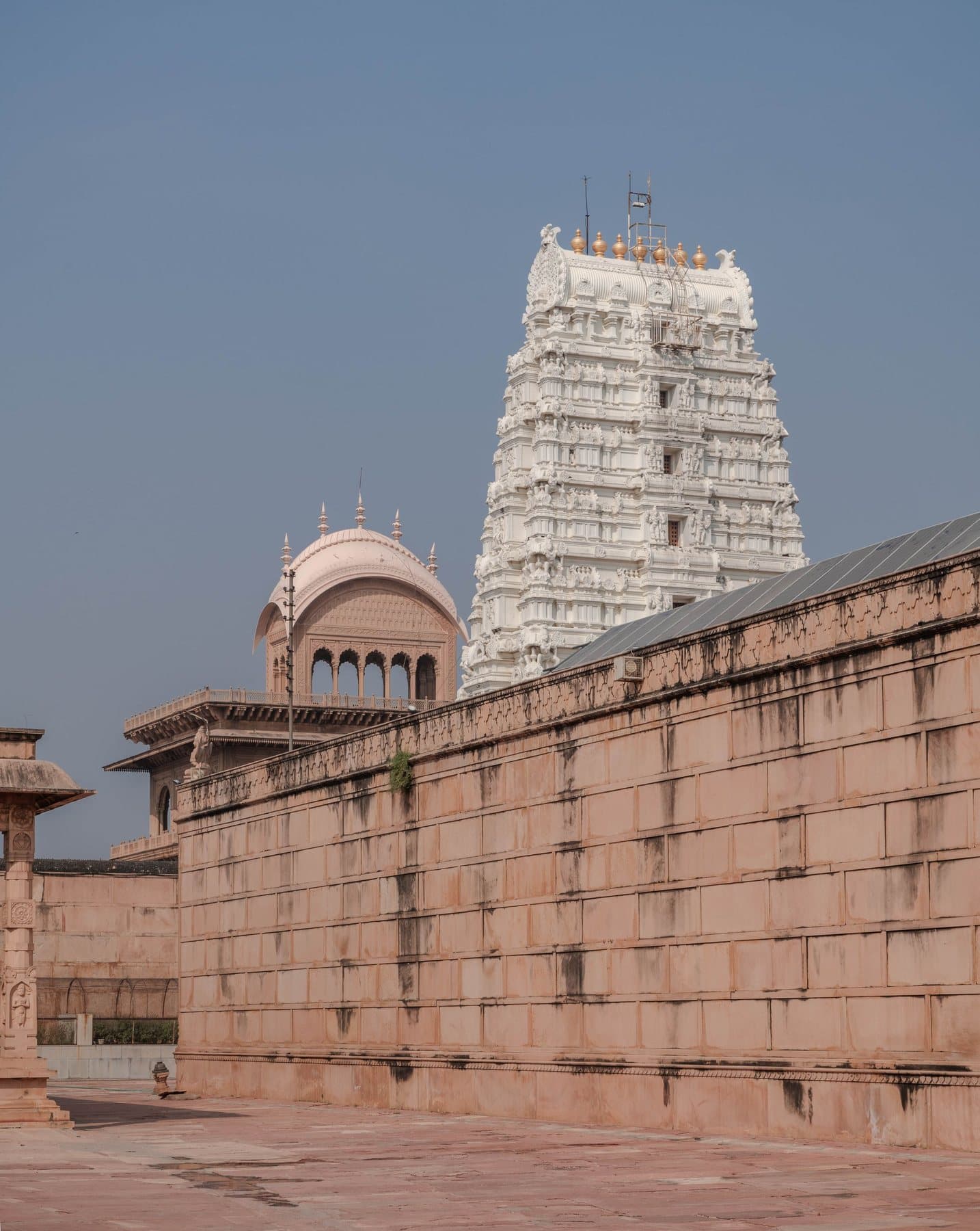 The white gateway tower of Rangji Temple above its sandstone walls, Vrindavan