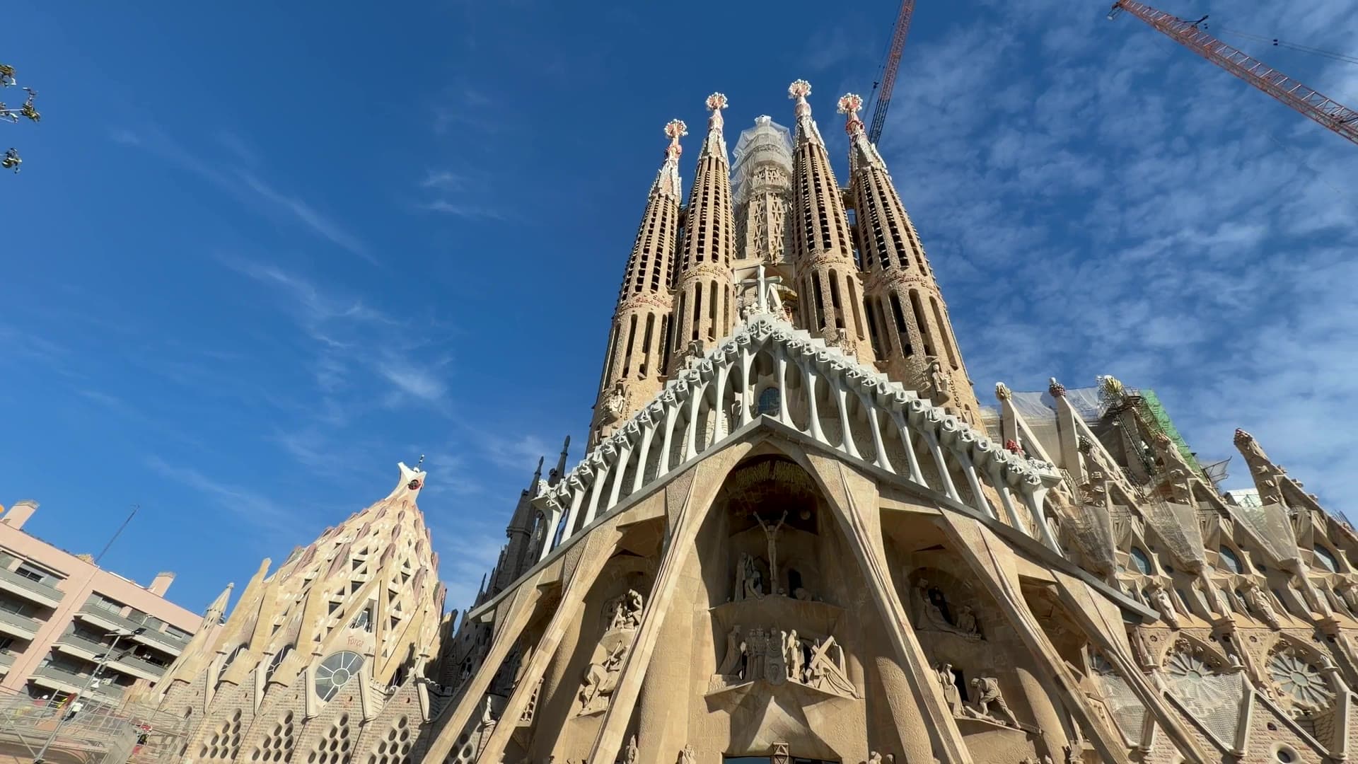 The Sagrada Família seen from below against a blue sky