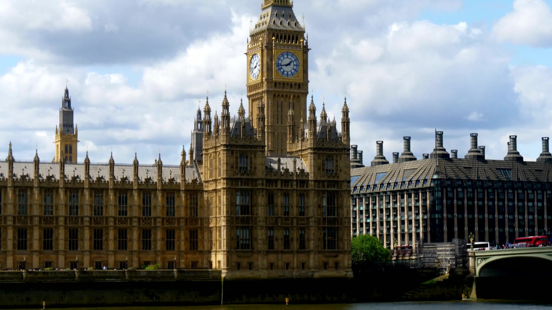 Big Ben and the Houses of Parliament under a blue sky with clouds