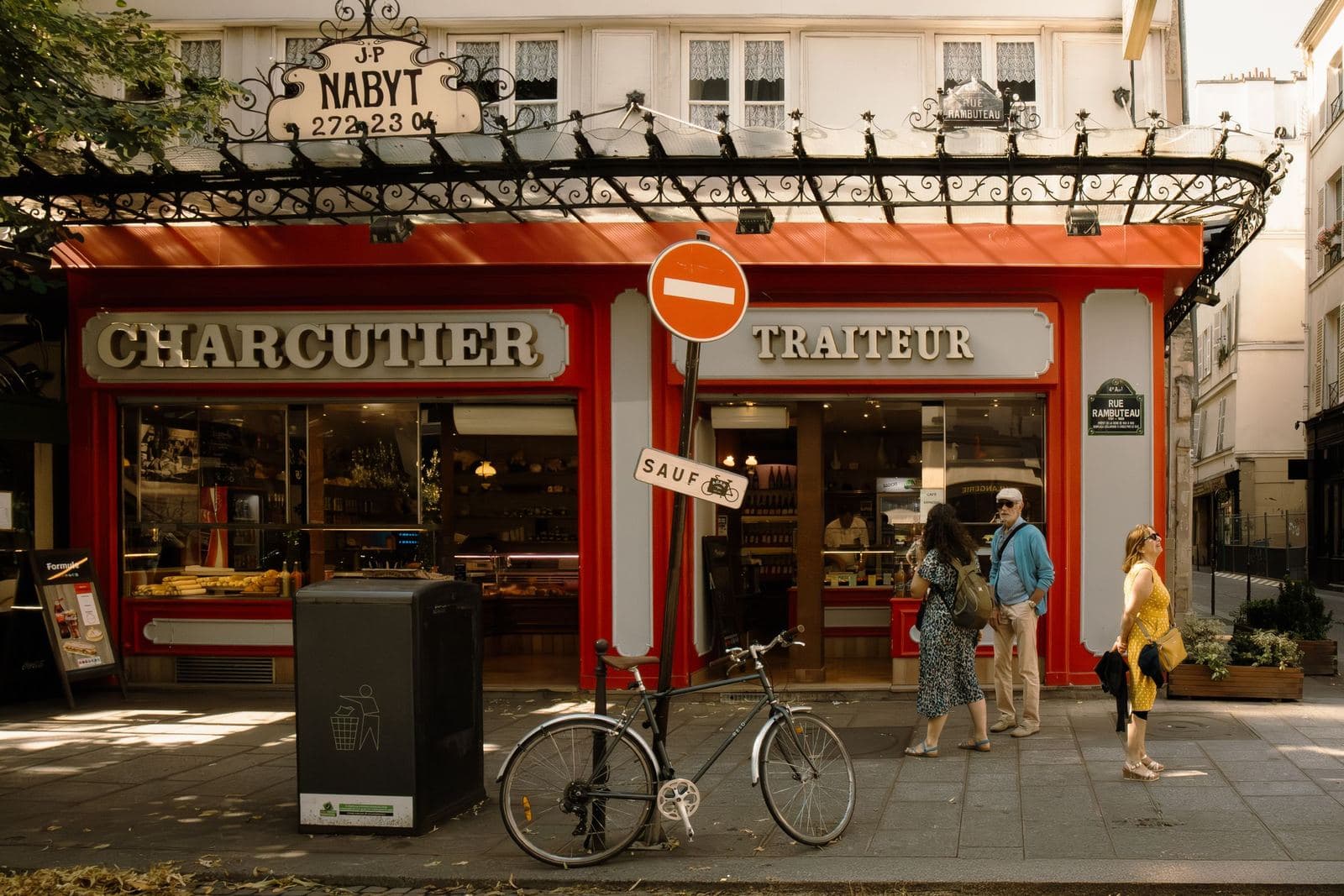 Traditional charcuterie shopfront on a sunny Paris street