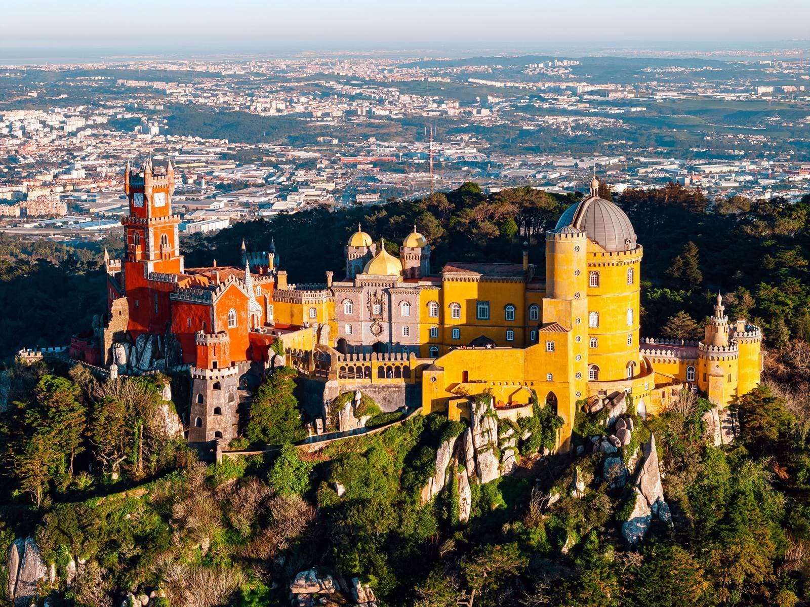 Pena Palace on its hilltop above the forests of Sintra, with the countryside beyond