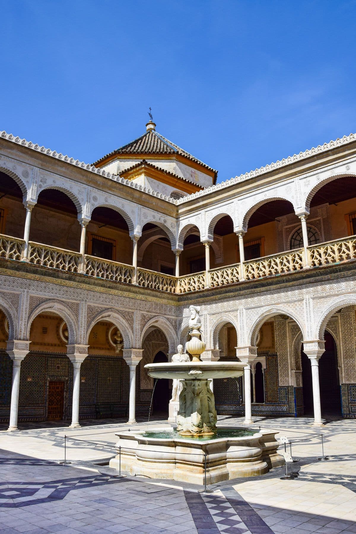The main courtyard of the Casa de Pilatos in Seville, with its fountain and arcades