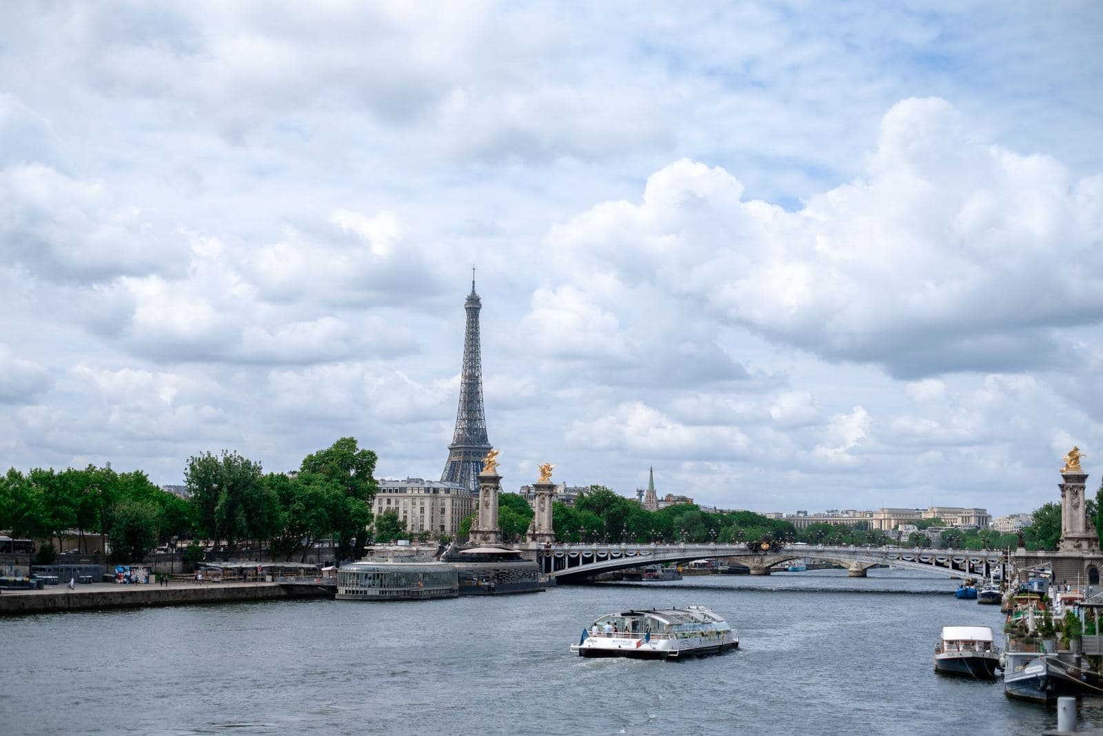 River Seine with sightseeing boats and the Eiffel Tower on the skyline
